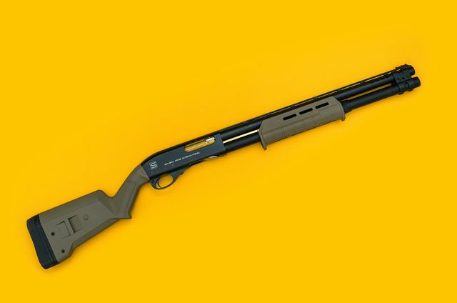 Fusil à pompe à crosse et garde-main beiges posé sur un fond jaune